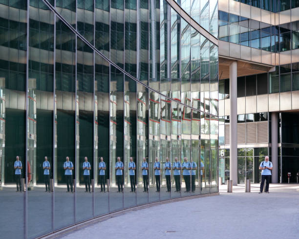 istock a man reflected in the wall of an office building 2151254938