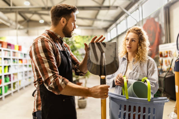 istock Customer and Salesman Pick Out Garden Tools Together 2151254965