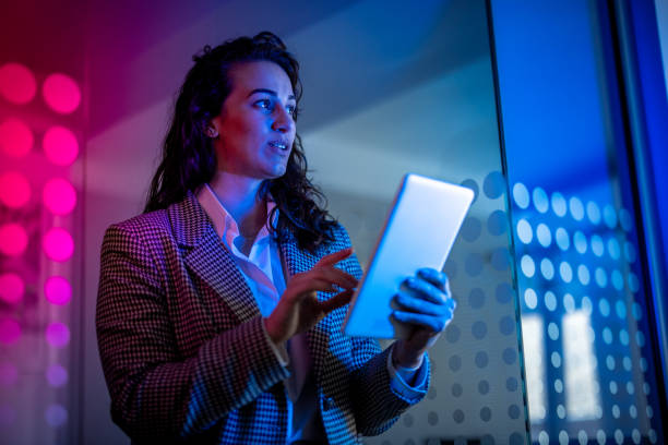 istock Young female entrepreneur with tablet working in virtual office. Woman touching virtual screen. Woman with VR  glasses working in office. 2151254998