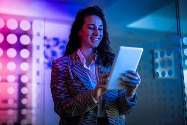 istock Young female entrepreneur with tablet working in virtual office. Woman touching virtual screen. Woman with VR  glasses working in office. 2151255001