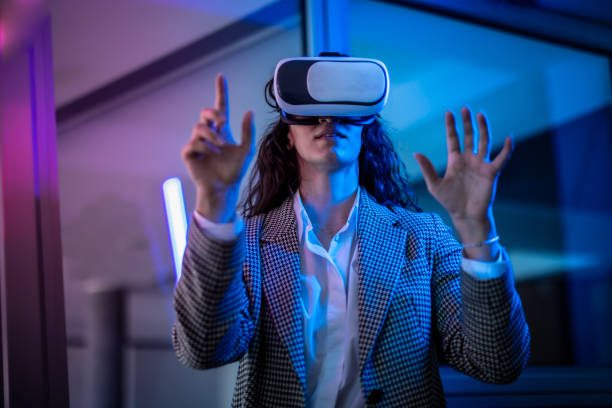 istock Young female entrepreneur with tablet working in virtual office. Woman touching virtual screen. Woman with VR  glasses working in office. 2151255394