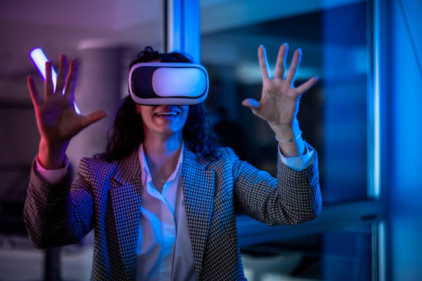 istock Young female entrepreneur with tablet working in virtual office. Woman touching virtual screen. Woman with VR  glasses working in office. 2151255430
