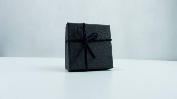 istock Black gift box with texture with black ribbon isolated on white background 2151255628