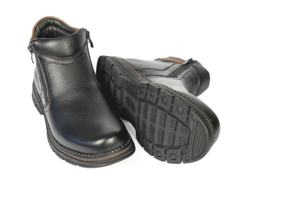 Men's black winter boots one on side on white background, isolated front view
