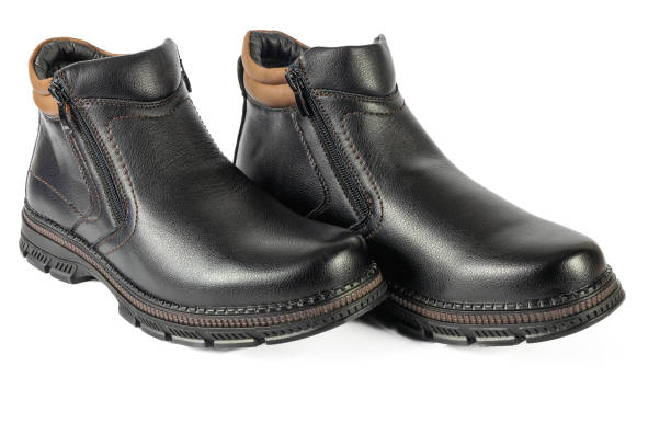 Men's black winter boots on white background isolated close-up view