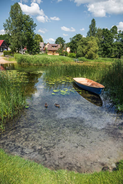 Rural Tourism Landscape With Boat In A Blue Lake