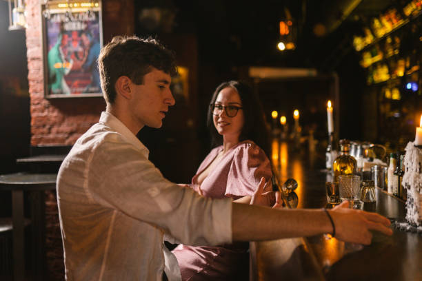 istock Pretty lady wants meet young guy at bar counter in pub 2151257871