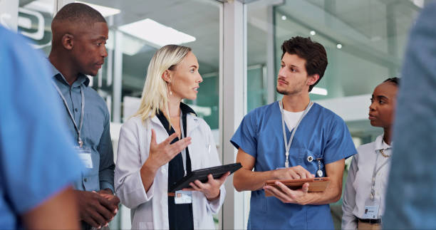 istock Doctors, group and meeting on tablet for medical planning, advice and support in teamwork or hospital solution. Healthcare staff, people and leader on digital technology and talking of clinic results 2151265510