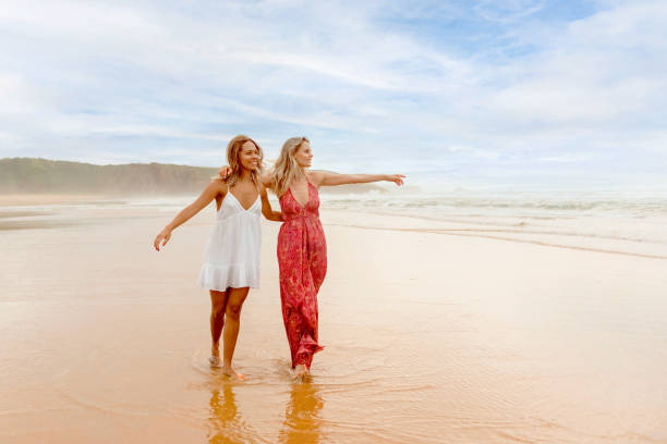 istock couple walking on the beach 2151265707