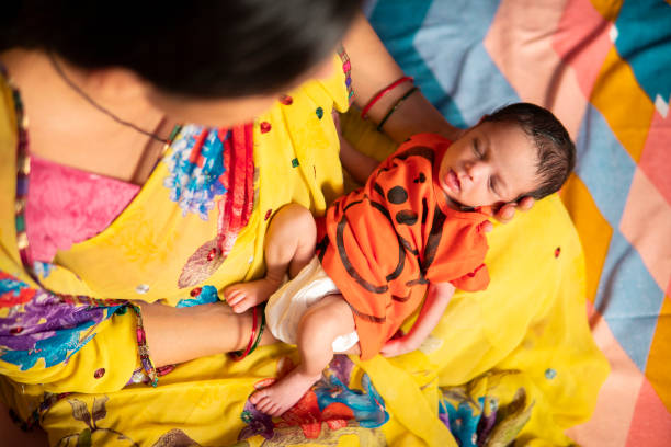 Newborn baby sleeping in mother arms.