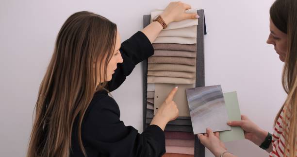 istock Interior designers select fabrics, paint from mood board for home renovation, discussing color scheme details. Meticulous interior design process, expertise in creating stylish, harmonious spaces. 2151268059