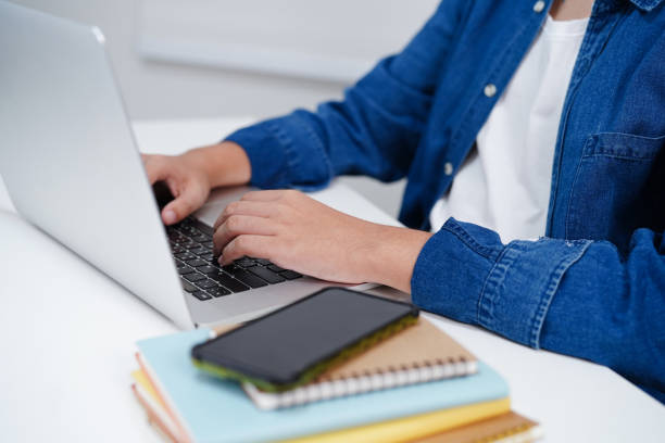 istock Asian teenage student write homework with laptop computer, learning university education concept. 2151269371