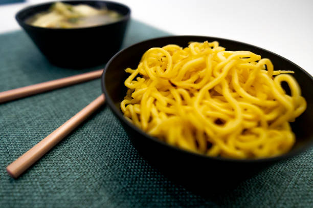 Yakissoba in lunchbox and bowl with chopsticks Chic Asian food