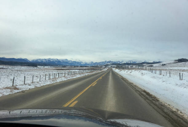 istock POV from vehicle driving on winter road 2151270584