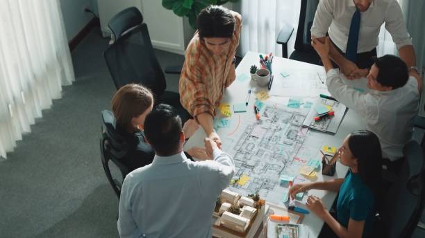 istock Group of diverse team planning strategy while sitting at table. Alimentation. 2151270688