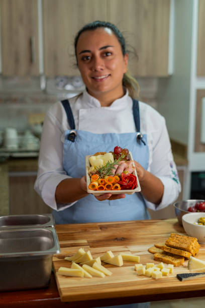 istock The beautiful chef prepares a cheese board from her home kitchen 2151273101