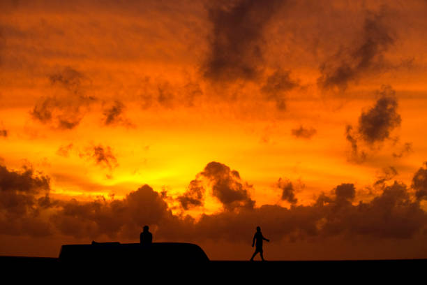 Silhouette of people by the beach