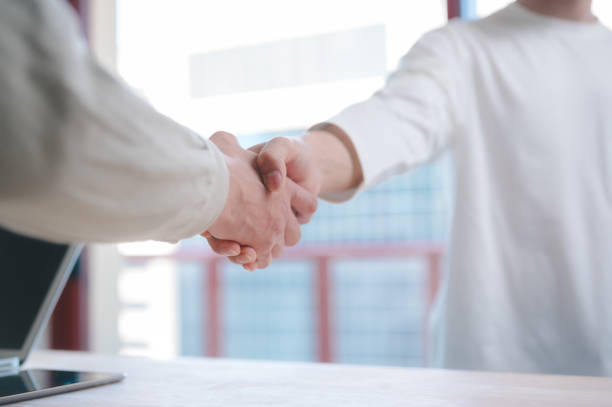 istock Businessmen handshake with partner greeting dealing merger and acquisition, business joint venture concept, teamwork and successful business with blurred background 2151274427