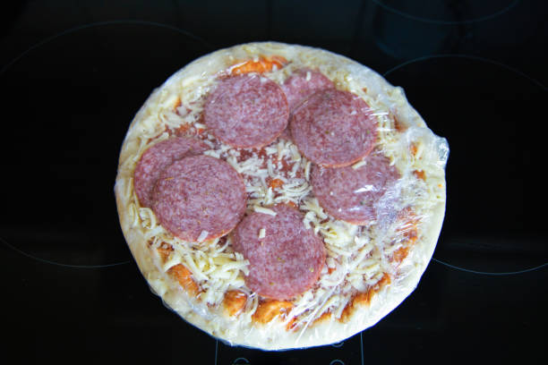 Frozen semi-finished pizza from the supermarket. Fast food concent