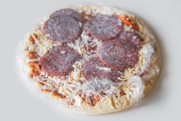 Frozen semi-finished pizza from the supermarket. Fast food concent