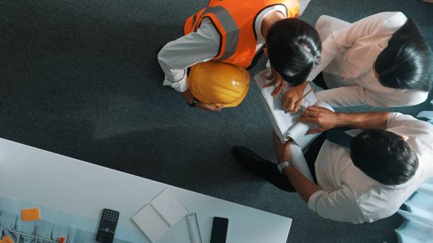 istock Top view of engineer hold laptop while explain idea to architect. Alimentation. 2151275505