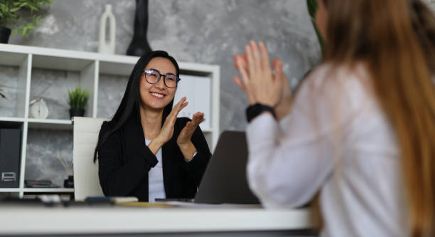 istock A successful business meeting with teamwork and collaboration, featuring a diverse group of professionals, including a young Asian businesswoman, in a modern office setting. 2151275926