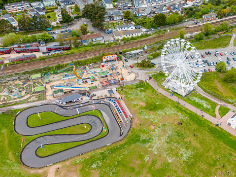 Dawlish Warren, UK. 3 May 2024. Aerial view of big wheel at Dawlish Warren with people on the footpath and in the park.