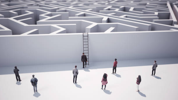 istock Businessman Trying to Climb Triangle Shaped Maze with Ladder 2151277008
