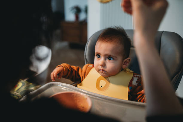 A cute baby is eating for lunch