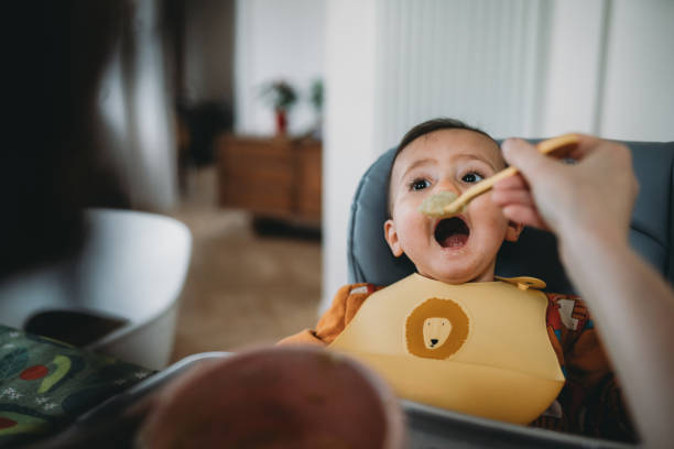 A cute baby is eating for lunch