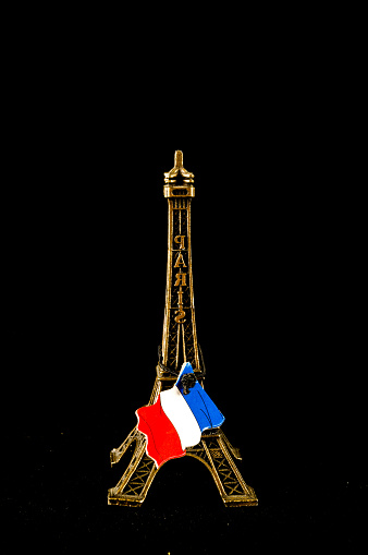 Eiffel Tower toy miniature on black background