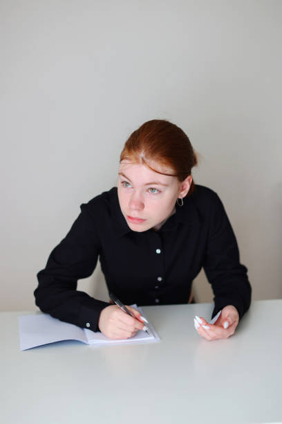 istock student doing examination, use pencil to write on paper and look at answers on another hand to cheat the test 2151280558