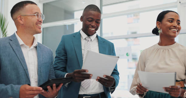 istock Coaching, documents and technology with team of business people in office for discussion or planning. Collaboration, meeting or strategy with man and woman employee group talking in workplace 2151282821