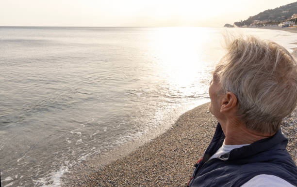 istock Profile of senior man looking towards sea 2151285127
