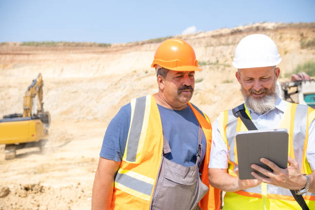 istock A manager and a worker work together in a kaolin quarry. 2151285280