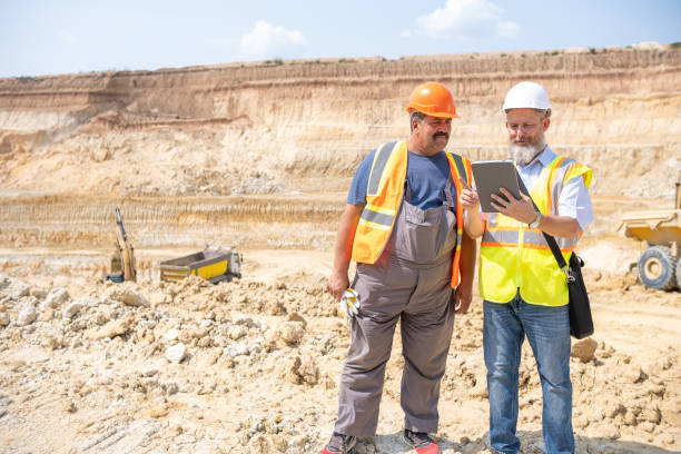 istock A manager and a worker work together in a kaolin quarry. 2151285298