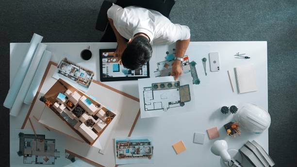 istock Top view of smart business man using tablet planning house design. Alimentation. 2151287427