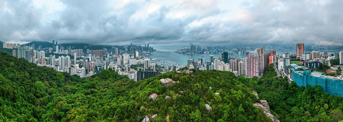 Drone view of Hong Kong city skyline with crowded skyscrapers on a cloudy day