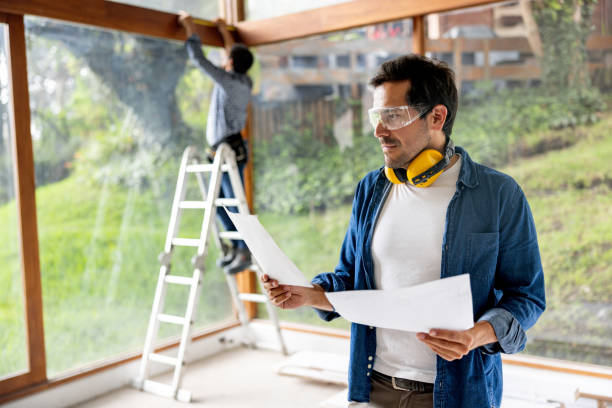 istock Architect renovating a house looking at some blueprints at the construction site 2151288688