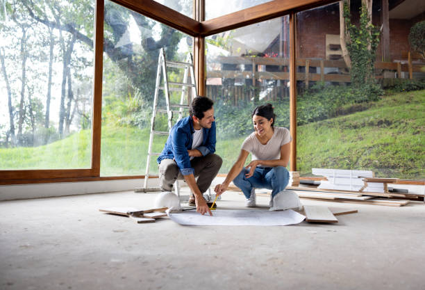 istock Couple remodeling their house and sharing ideas while looking at a blueprint 2151288715