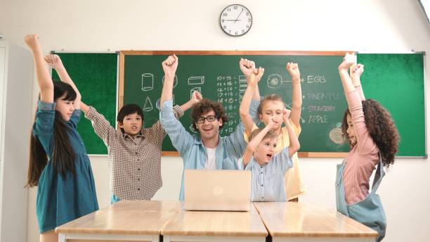 istock Teacher and student looking at laptop while celebrate success project. Pedagogy. 2151291701