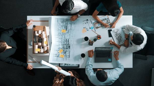 Top view of project manager or engineer writing at blueprint. Alimentation.