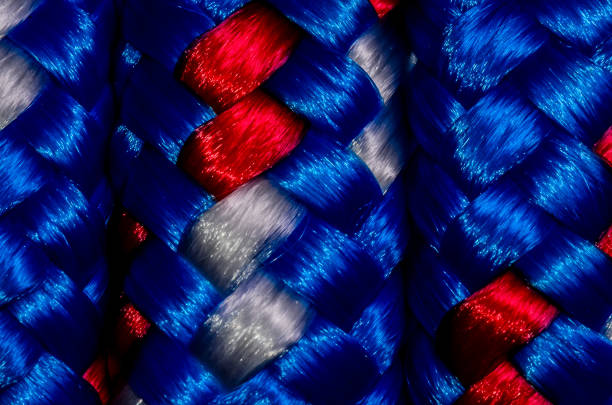 A close up of a blue, red, and white rope. The colors are vibrant and the rope appears to be woven in a pattern. Scene is energetic and dynamic, as the colors
