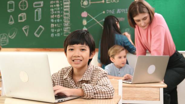 istock Boy coding engineering prompt while attractive girl drawing picture. Pedagogy. 2151294968