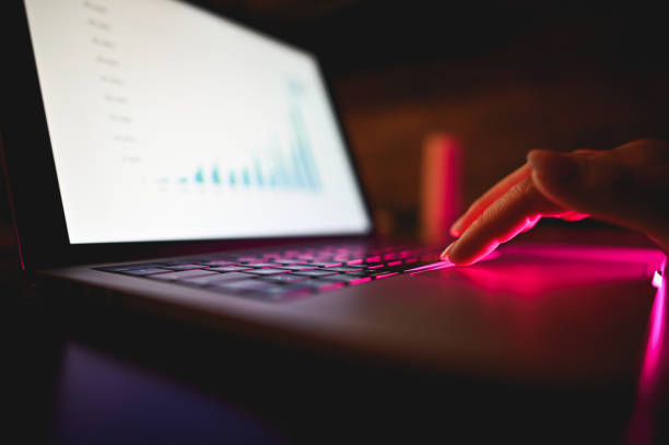 laptop keyboard with a stock market graph