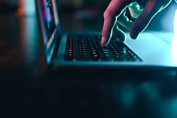 istock Human finger and laptop keyboard close up at night. 2151295125