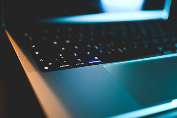 istock Close up of a laptop keyboard with neon lighting. 2151295128