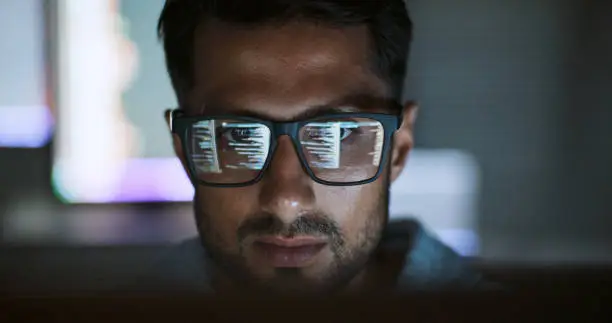 Photo of Hispanic Latin American man, software engineer developer use computer at home office, work on program coding at night. Programming language development technology, freelance work from home concept
