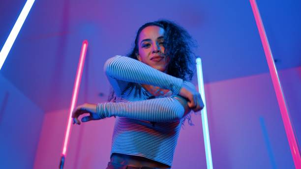 istock Low angle camera of hispanic dancer looking at camera and dancing. Regalement. 2151296220