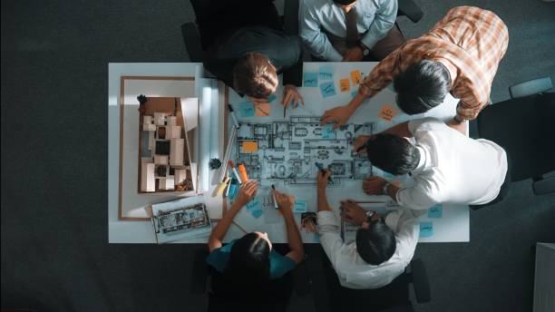 istock Top view of project manager or engineer writing at blueprint. Alimentation. 2151297132